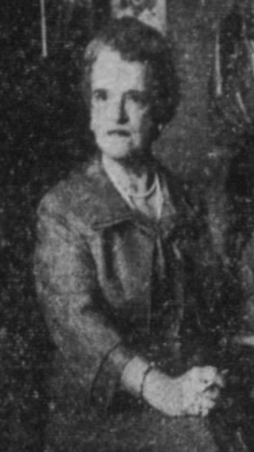 Doris Doe, from a 1959 newspaper photo; an older white woman with short greying hair, wearing a suit, hands clasped in her lap
