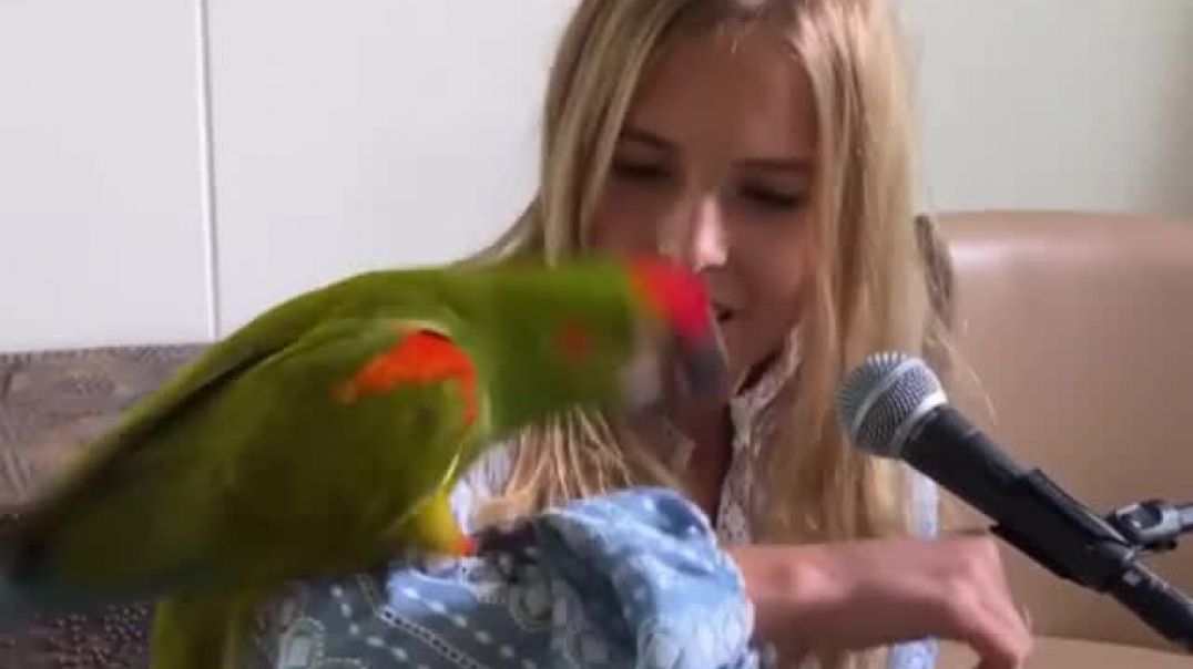 ⁣⁣Emily with her cute parrot Rocky
